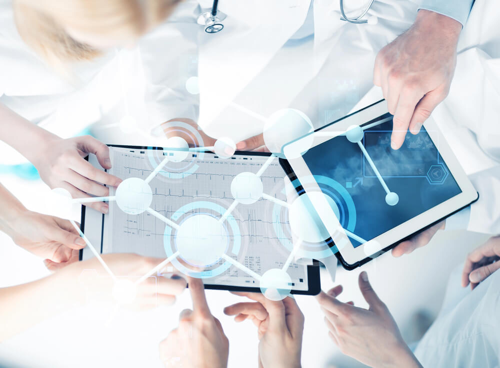 healthcare cybersecurity solutions - an image showing healthcare workers leveraging technologies