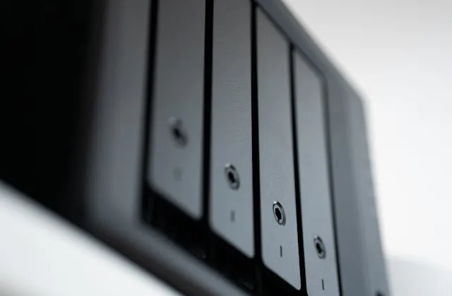 Rack of hard drive bays representing backup and disaster recovery storage