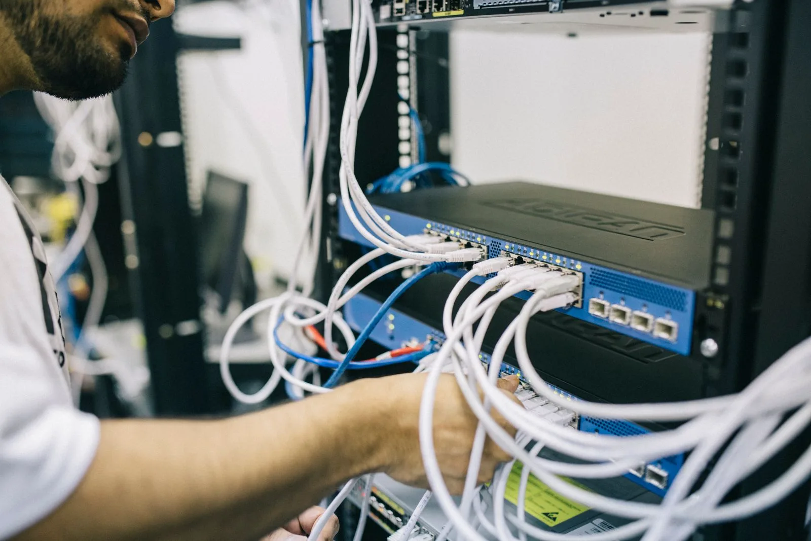 A technician wiring network infrastructure in a distribution facility