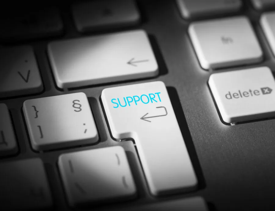 A keyboard with a blue SUPPORT key, fast, friendly IT support