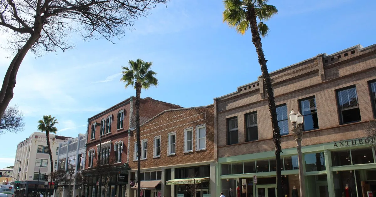 Historic brick storefronts and palm trees along Colorado Boulevard in Old Town Pasadena, CA